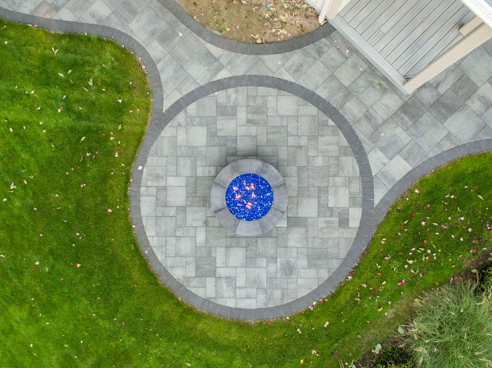 Outdoor living space with fire pit and pavers by Sequoia Stonescapes